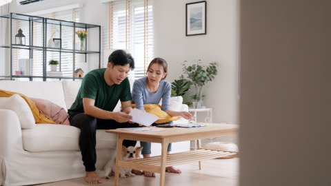 A young couple considerin the cost of installing a standby generator